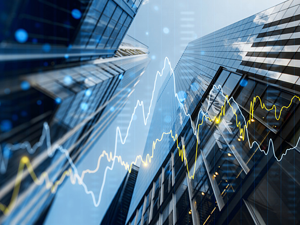 Skyscrapers overlaid with economic charts